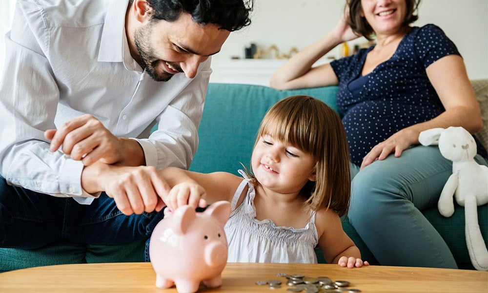Family saving money in a piggybank 
